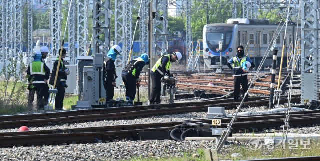 29일 인천 계양구 인천교통공사 귤현차량사업소 기지 구내에서 토목파트 직원들이 자갈도상 작업에 매진하고 있다. 자갈도상 작업은 느슨해진 자갈을 다짐기계로 단단하게 다짐하는 것으로 궤도의 변형을 방지하고 열차하중을 지반에 고르게 전달되도록 하는 작업이다. 조병석기자