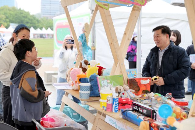 박승원 광명시장(오른쪽)이 광명시민체육관에서 열린 어린이날 기념행사에서 플리마켓에 참여한 어린이와 인사를 나누고 있다. 광명시 제공
