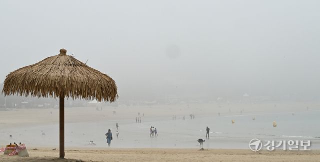무더운 날씨를 보인 18일 오후 인천 을왕리 해수욕장에 짙은 해무가 깔린 가운데 피서객들이 물놀이를 즐기고 있다. 조병석기자 .