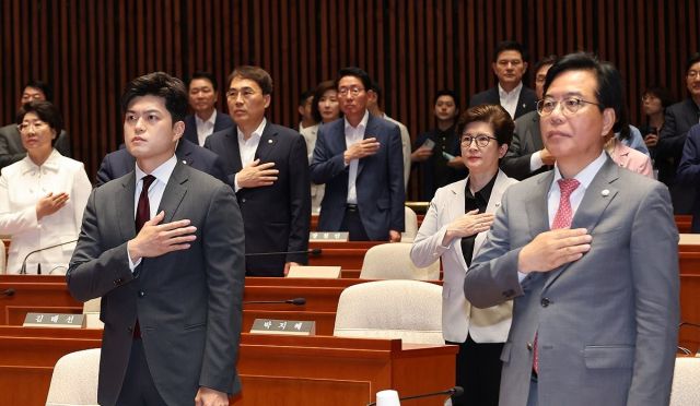 국민의힘 김용태 비상대책위원장과 송언석 원내대표가 20일 서울 여의도 국회에서 열린 '비리백화점 이재명 정부 인사청문회 대책 긴급 의원총회'에서 국기에 경례하고 있다. 연합뉴스