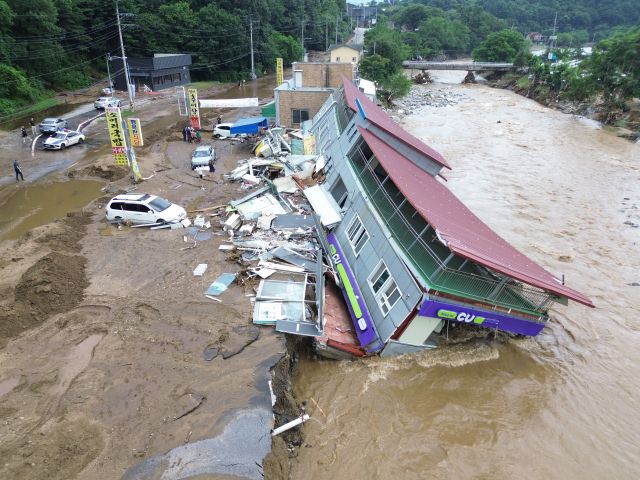 20일 가평군 조종면 신상리 십이탄천 인근에서 폭우로 붕괴된 편의점 건물이 물에 잠겨 있다. 집중호우로 인근 주택 3채도 산사태에 파손됐으며, 주민들은 단전과 단수 피해를 겪고 있다.조주현기자