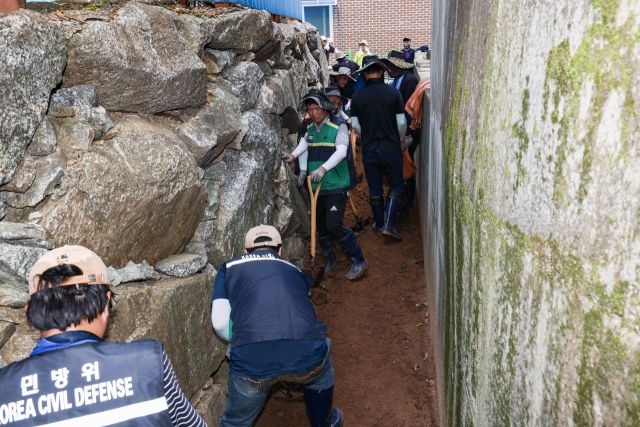 김덕현 연천군수와 직원들이 가평군 호우 피해현장을 찾아 토사 제거 등 피해복구작업을 하고 있다. 연천군 제공