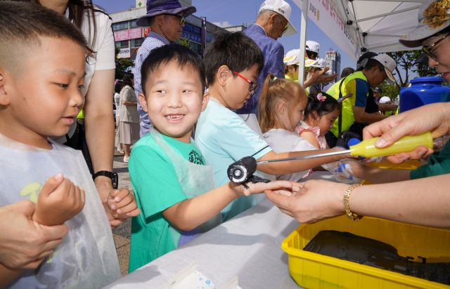 10일 오전 광복 80주년을 맞아 상록수역 손바닥 페인팅 행사에서 시민들과 아이들이 태극기에 손도장을 찍을 준비를 하고 있다.