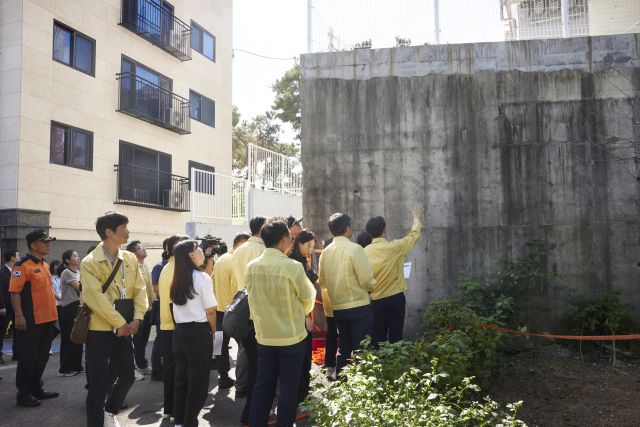 김동연 경기도지사가 최근 집중호우로 금이 가 붕괴 우려가 나온 수원시 장안구 파장동의 한 다세대주택 옹벽을 살펴보고 있다. 경기도제공.