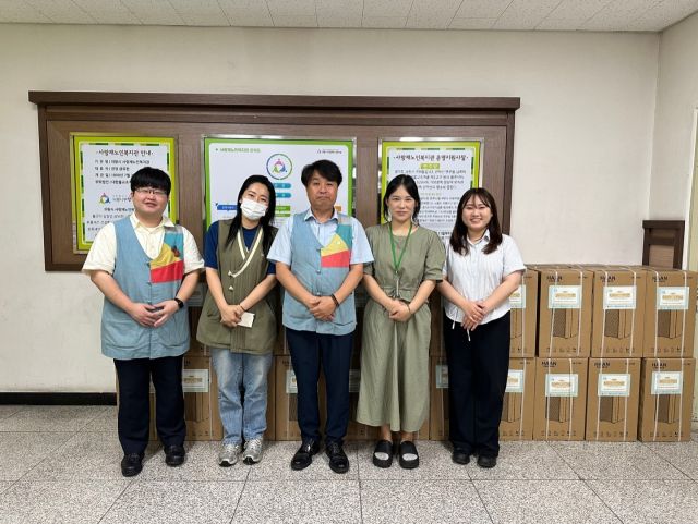 의왕시사회복지협의회 금유현 회장(가운데)과 관계자들이 어려운 이웃에 전달할 제습기 앞에서 기념촬영을 하고 있다. 의왕시사회복지협의회 제공