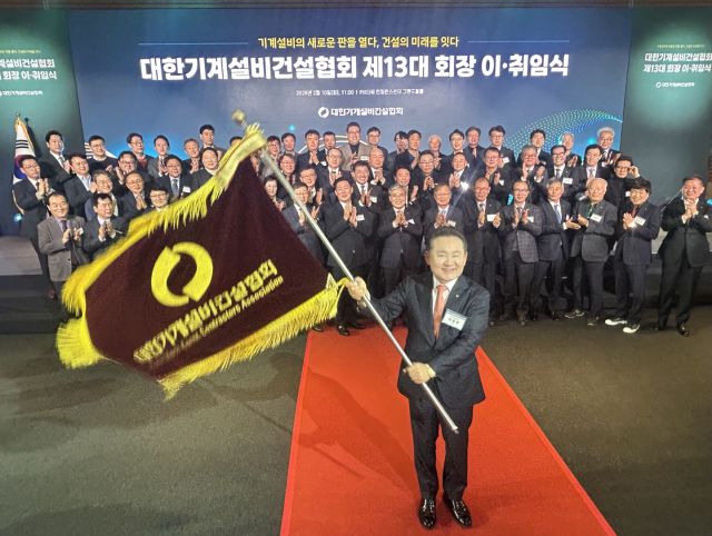 허용주 대한기계설비건설협회 회장이 인수인계 받은 협회기를 휘두르고 있다. 한양경제 나경식 기자