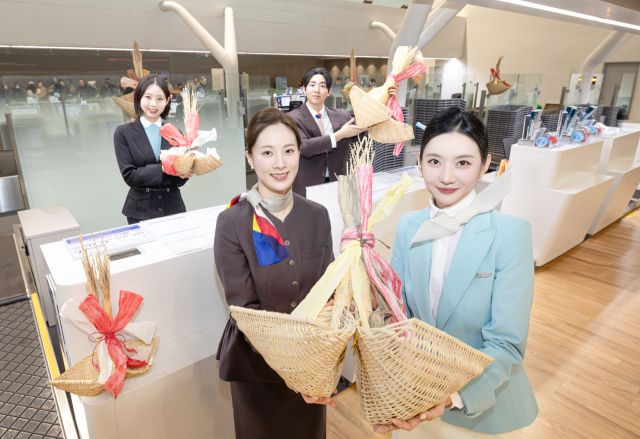 대한항공과 아시아나항공은 병오년(丙午年) 설 연휴를 앞둔 10일 국내 주요 사업장에서 설 맞이 복조리 걸기 행사를 했다. 행사에 참여한 각 사 직원들이 인천공항 제2여객터미널 탑승 수속 카운터에서 기념촬영을 하고 있다. 대한항공 제공