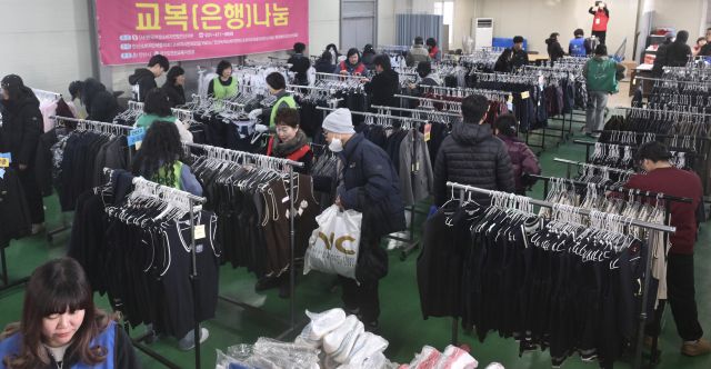 21일 안산시 산업지원본부 교복상설매장에서 열린 ‘교복 나눔 행사’를 찾은 학부모와 학생들이 교복을 살펴보고 있다. 안산시는 이번 행사를 통해 교복 구매 부담을 덜고 자원 순환 문화를 확산한다는 계획이다.조주현기자