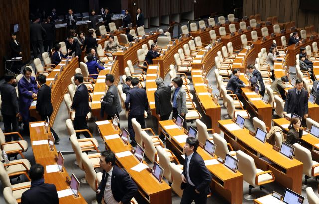 국민의힘 윤한홍 의원이 24일 국회에서 열린 2월 임시국회 8차 본회의에서 상법 일부개정법률안(대안)에 대한 무제한 토론(필리버스터)에 돌입하자 더불어민주당 의원들이 퇴장하고 있다. 연합뉴스