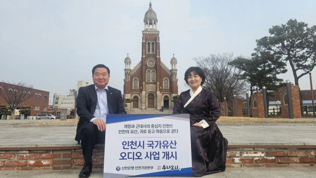 11일 인천 중구 답동성당 앞에서 남창신 신한은행 인천기관본부장과 오디오 녹음에 참여한 김경아 명창이 ‘인천시 국가유산 오디오 가이드’ 첫 설치 장소에서 기념촬영을 하고 있다. 신한은행 제공