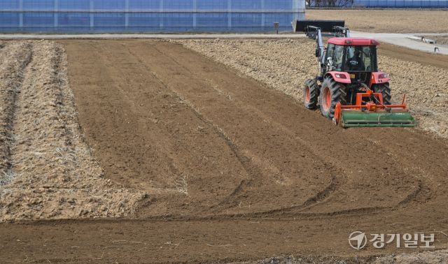 흙의 소중함을 알리고 건강한 토양 보전을 위해 제정된 ‘흙의 날’인 11일 오전 화성특례시 병점구 경기도농업기술원 연구용 밭에서 관계자들이 겨우내 창고에 보관했던 트랙터와 로터리 등 농기계를 점검하고 있다. 홍기웅기자