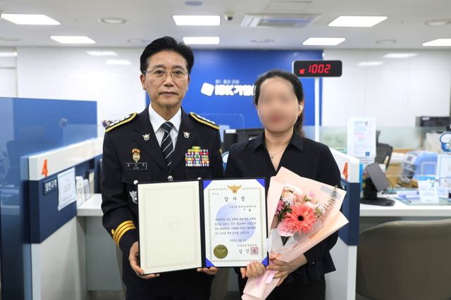 김신조 안양동안경찰서장(왼쪽)이 보이스피싱 피해 예방 및 범인 검거에 결정적인 기여를 한 IBK기업은행 직원 A씨에게 감사장을 수여했다. 안양동안경찰서 제공