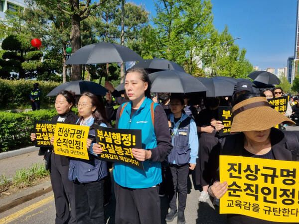 인천의 교원 단체가 특수 교사 A씨의 순직 인정을 요구하며 검은 우산을 들고 도보행진 시위를 벌이고 있다. 경기일보DB