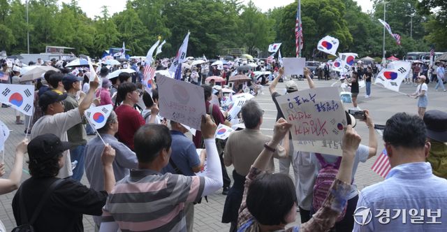 제9회 전국동시지방선거 투표용지 부족 사태에 반발한 시민들이 14일 서울시 송파구 올림픽공원 핸드볼경기장 일대에 모여 애국가를 부르거나, '부정선거, 재선거, 당일투표, 수개표' 요구하는 구호를 외치고 있다. 홍기웅기자