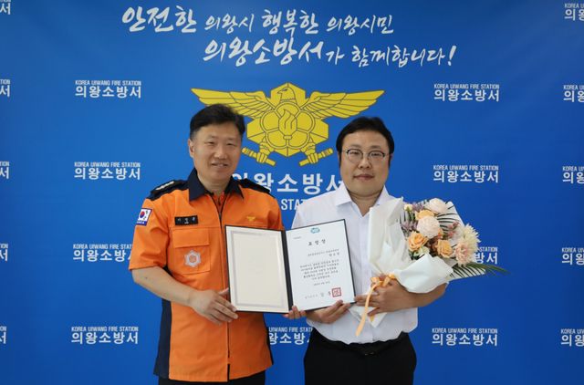 롯데글로벌로지스 의왕제과센터 양오영 소방안전관리자(오른쪽)가 2026년 경기 창의 안전 대상을 수상한 뒤 이정용 의왕소방서장과 기념촬영을 하고 있다. 의왕소방서 제공