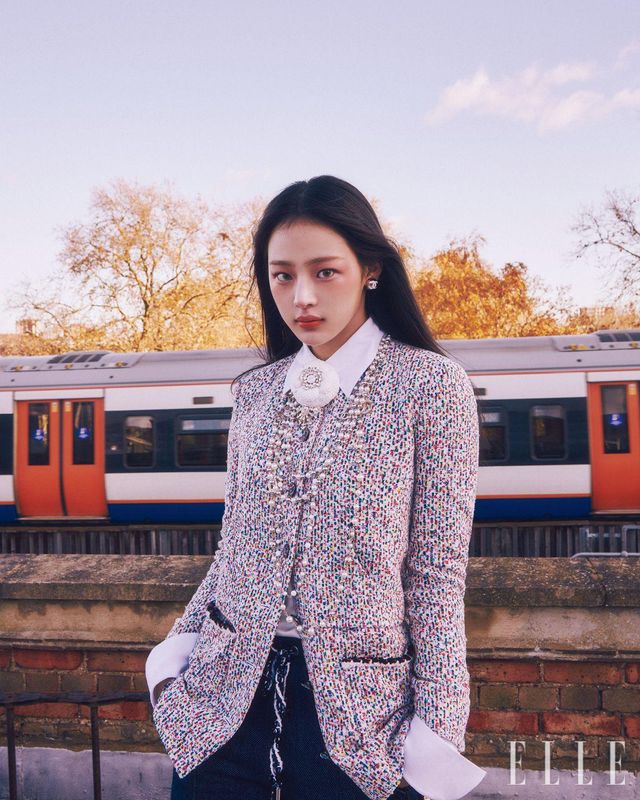 맑고 신선한 런던의 공기가 쿨한 민지를 에워싸던 순간. 레 베쥬 쿠션을 얼굴 전체적으로 얇고 고르게 바른 뒤 N°1 DE CHANEL 레드 까멜리아 립 앤 치크 밤, 2 헬시 핑크를 눈 밑부터 양볼까지 넓게 펴 발라 쌀쌀한 날씨에 살짝 상기된 듯한 치크 메이크업을 완성한다. 또렷함을 더하기 위해 스틸로 쑤르씰 오뜨 프레시지옹, 154 블롱 땅드르로 눈썹의 빈 곳을 메우듯 그려주고, 입술에 얇은 코팅 막을 형성해 눈부시게 빛나는 색감을 자랑하는 루쥬 코코 플래쉬, 90 쥬르를 바른다. 사용 제품은 모두 Chanel. 트위드 재킷과 데님 버뮤다 팬츠, 화이트 까멜리아 코르사주와 펄 네크리스, 이어링은 모두 Chanel.