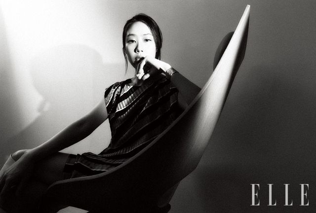 도나 하이 부츠, LV 볼트 링, 실크 슬리브리스 드레스와 LV 볼트 브레이슬릿은 모두 Louis Vuitton.