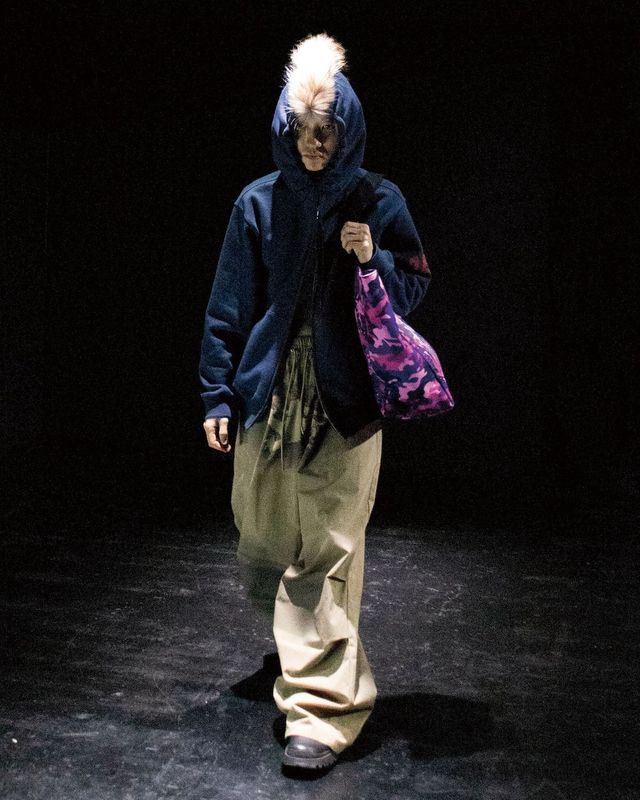 펑크 문화에서 착안해 펑키한 헤어스타일을 재해석한 모자와 타이포그래피 디테일이 눈에 띄는 2025 F/W 룩 북 이미지.