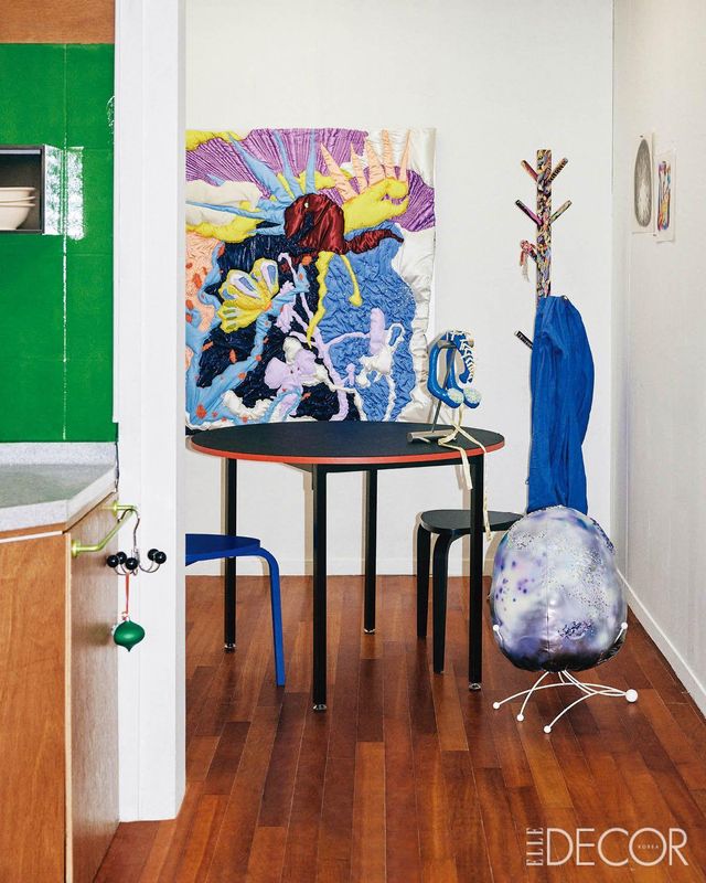 주방이 있는 별채. 벽에 걸린 패브릭 회화는 ‘With Them’. 테이블 위의 조각 작품은 ‘Thinker’. 바닥에 놓인 둥근 오브제는 ‘Egg’. 