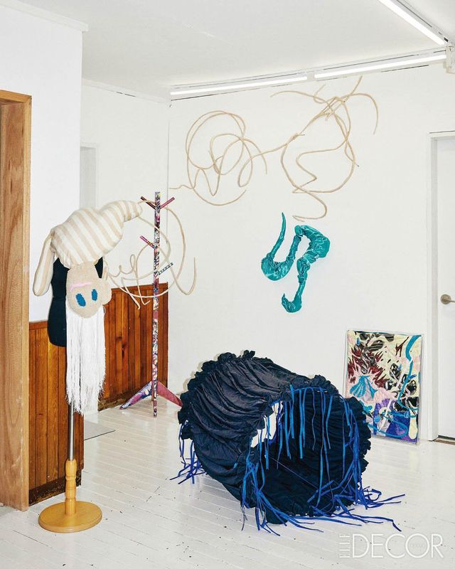 다양한 작품이 놓인 거실. 바닥에 놓인 오브제는 ‘My Blue’. 벽에 기댄 패브릭 회화는 ‘Nirvana’. 옷걸이에 매달린 인형은 우한나가 만든 작업실 마스코트 친년이.