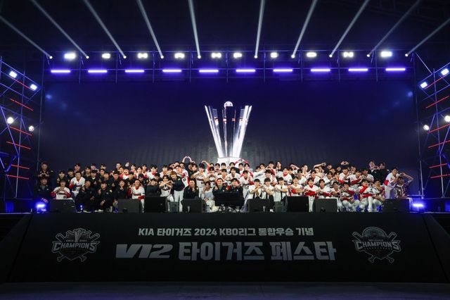 KIA 선수단과 프런트가 11월 30일 광주 김대중컨벤션센터에서 열린 ‘V12 타이거즈 페스타’ 도중 모두 함께 무대에 올라 팬들에게 감사인사를 전한 뒤 기념촬영을 하고 있다. 사진제공｜KIA 타이거즈