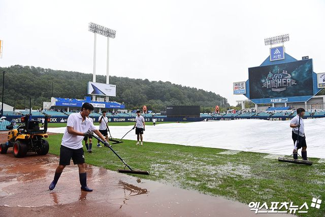 6일 오후 대구삼성라이온즈파크에서 열리는 '2025 신한 SOL Bank KBO 포스트시즌' NC 다이노스와 삼성 라이온즈의 와일드카드 1차전 경기에 앞서 구장 관리 요원들이 방수포의 물을 걷어내는 작업을 하고 있다. 대구, 박지영 기자