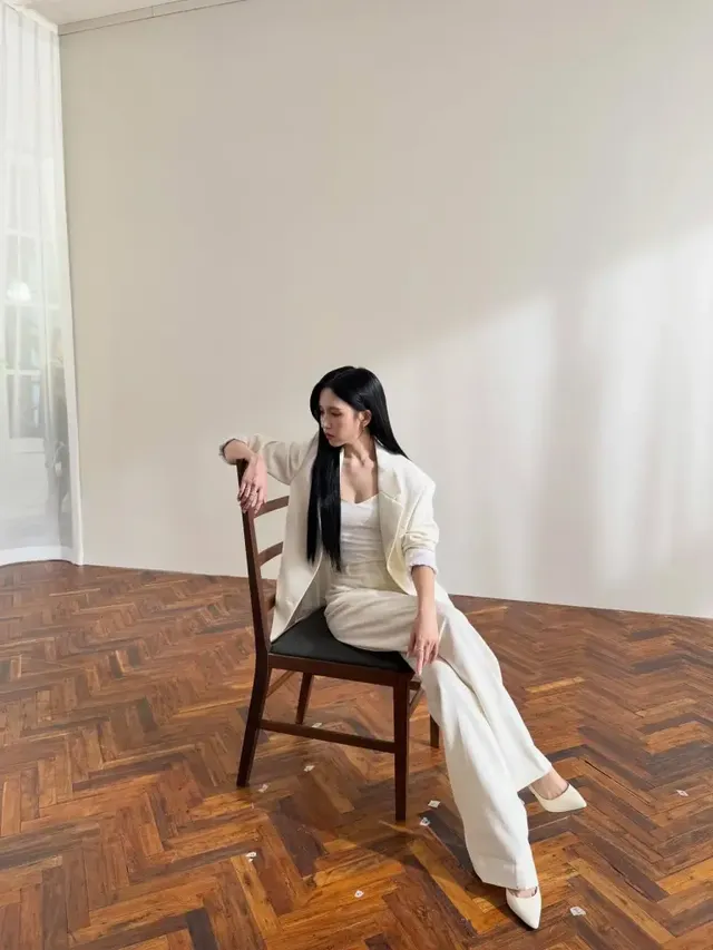 정갈한 화이트 수트에 슬리브리스 톱을 매치하여 현대적인 