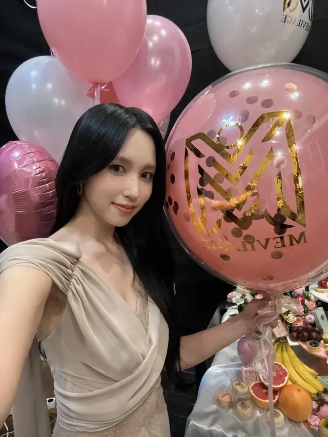 핑크와 골드 풍선으로 장식된 공간에서 베이지 드레이프 드레스로 우아한 자태를 선보이는 미나. /사진=미나 인스타그램인스타그램