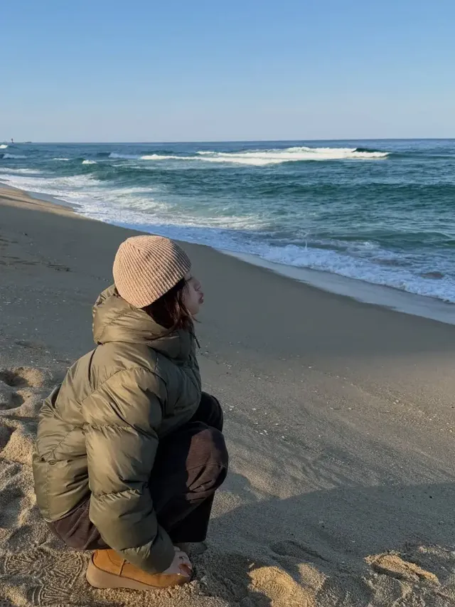 박규영이 모래사장에 앉아 여유로운 포즈를 취하며 따뜻한 톤온톤 스타일을 연출하고 있다. /사진=박규영 인스타그램