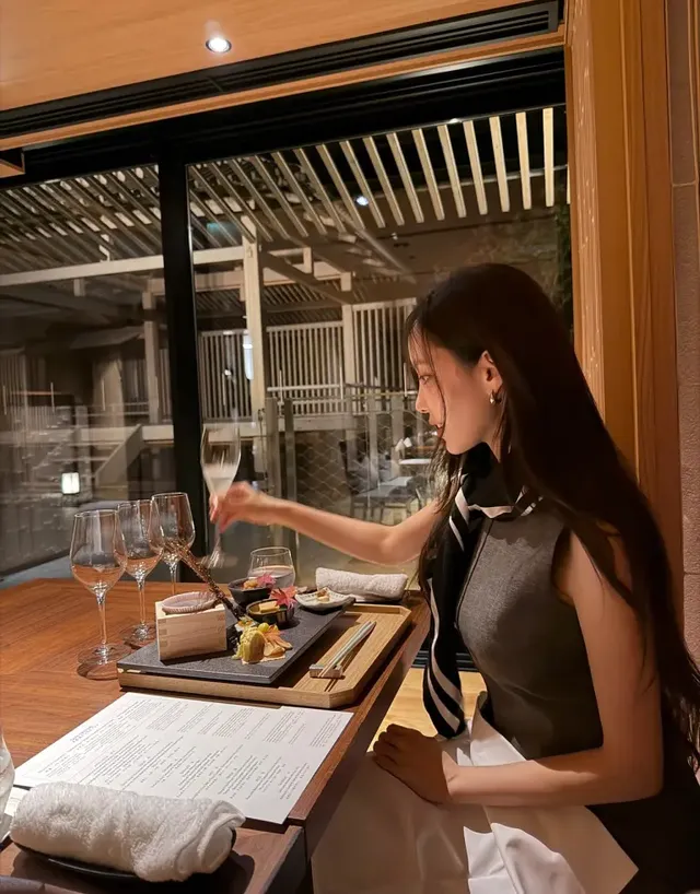 효민이 따뜻한 라운지 공간에서 베이지 재킷과 스트라이프 스카프를 매치하여 클래식한 톤온톤 룩을 선보이고 있다. /사진=효민 인스타그램